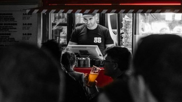 Capital brewing staff member takes orders for beer late at night